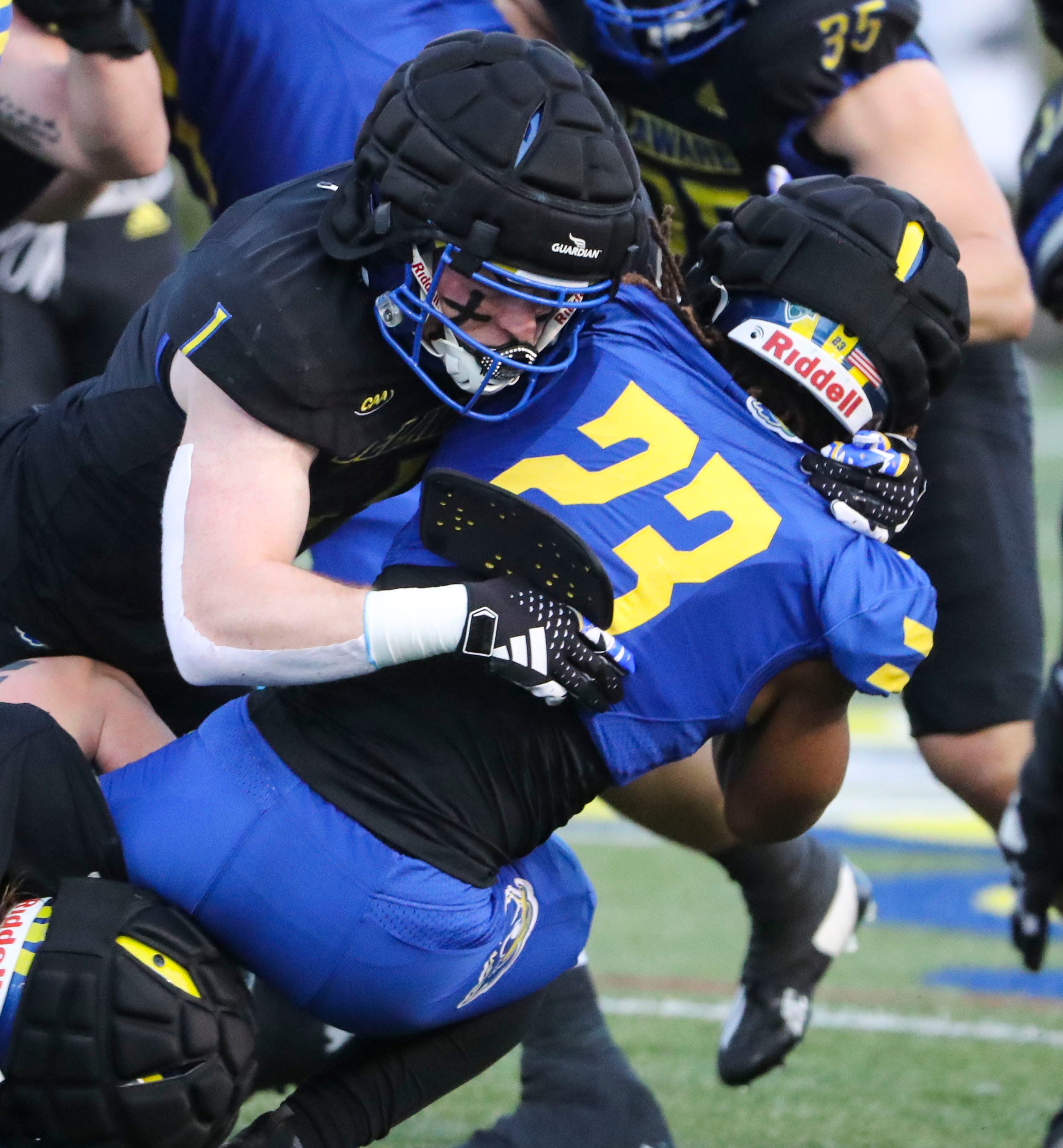 Delaware linebacker Ty Davis makes a tackle on running back Quincy Watson during the Blue and White Spring Game at Delaware Stadium, Friday, April 19, 2024.