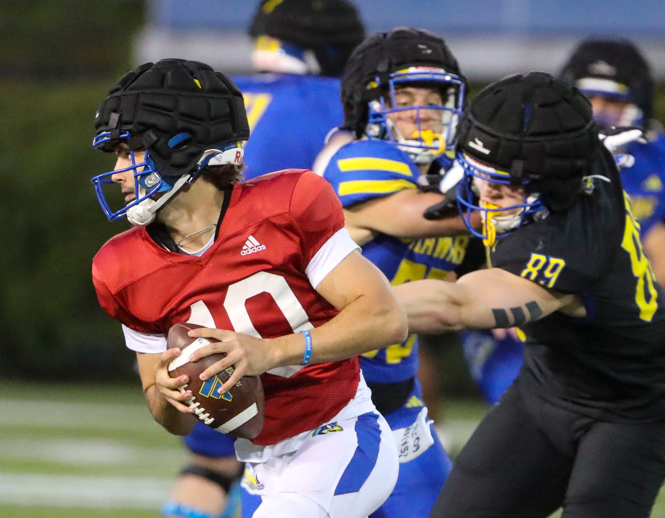 Delaware quarterback Daniel Lipovski is flushed form the pocket as defensive lineman Nate Ray (89) pursues during the Blue and White Spring Game at Delaware Stadium, Friday, April 19, 2024.