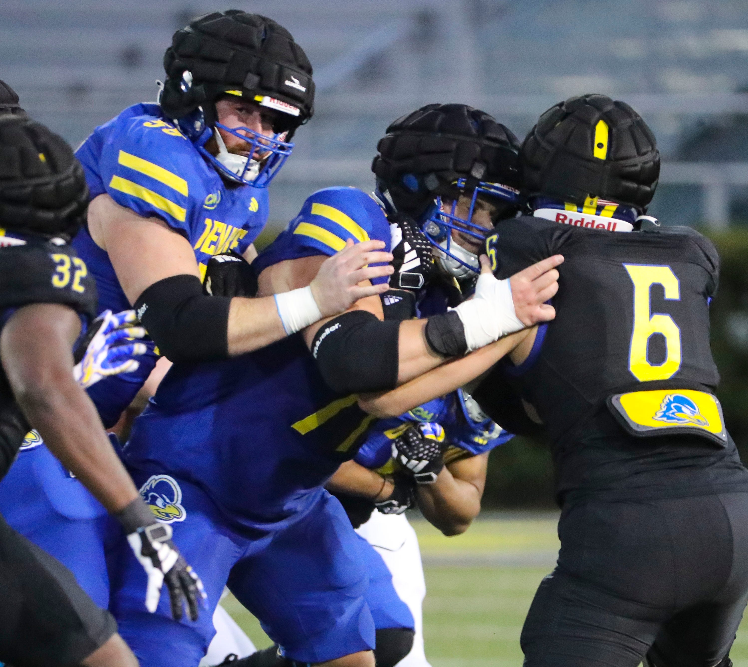 Delaware offensive linemen Brock Gingrich (left) and Cole Snyder block Amin Mimouni during the Blue and White Spring Game at Delaware Stadium, Friday, April 19, 2024.